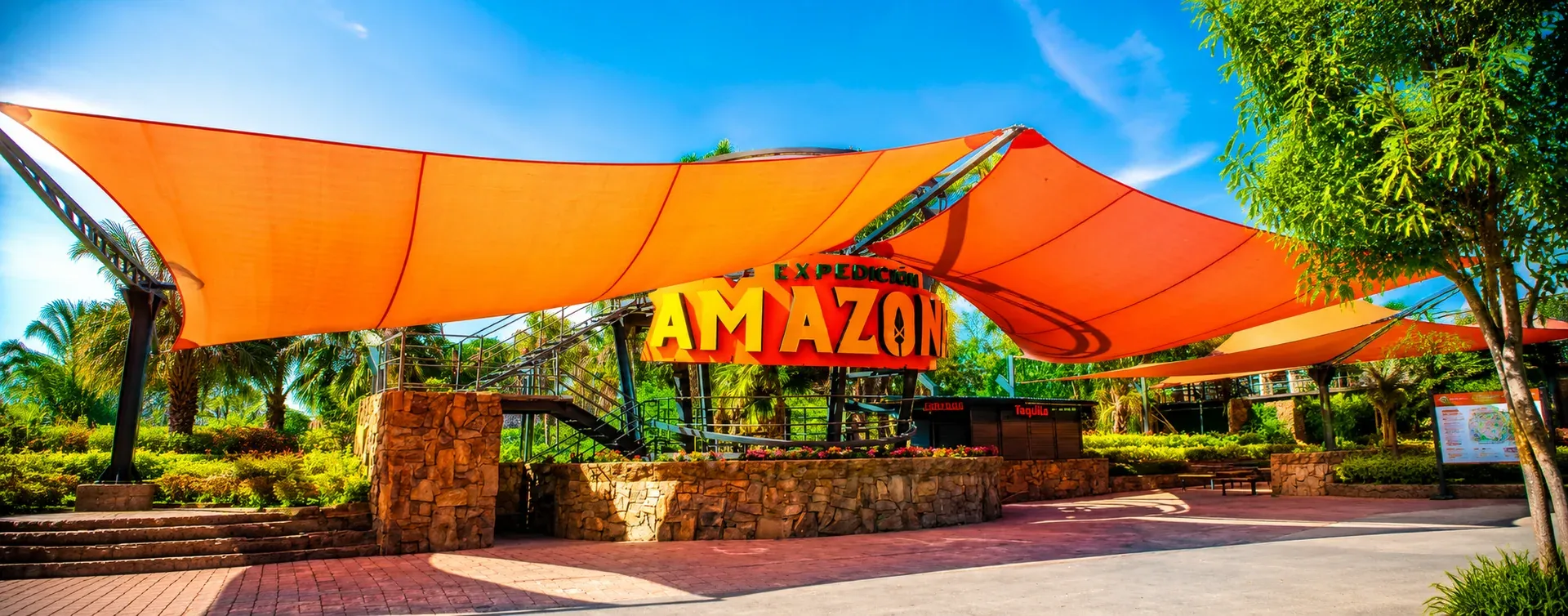Entrance to Parque Expedición Amazonia with its orange canopy, inside Parque Fundidora